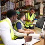 Team discussing warehouse logistics in an on-site office